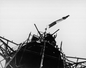 Photo of the tricolor flag raised at the top of the Eiffel Tower