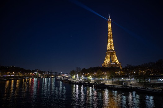 Photo of the Eiffel Tower lit up at night